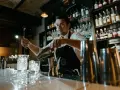 Barman w Anglii przygotowuje drinka. Zastanawiasz się, ile zarabia barman w Anglii?