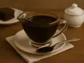 Pyszny, domowy sos czekoladowy z kakao. Idealny do ciasta brownie, które widać na talerzyku obok.