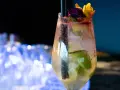 Orzeźwiający drink prosecco sprite z limonką i kwiatową dekoracją, idealny na letnie wieczory.