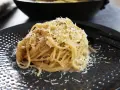 Pyszne spaghetti Cacio e Pepe, posypane startym parmezanem i świeżo mielonym pieprzem. Idealne na szybki obiad.