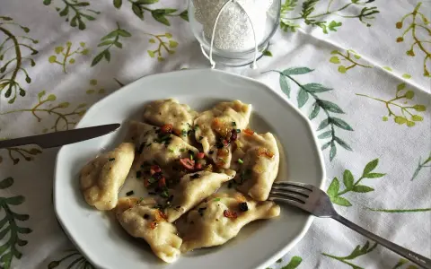 Pyszne pierogi z boczkiem i cebulką, gotowe do jedzenia. Idealny przepis na obiad.