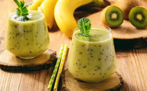 Orzeźwiający koktajl z jogurtem, kiwi i bananem, ozdobiony miętą. Idealny na letnie popołudnie.