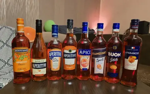 Pimm’s No. 1 kontra Aperol Spritz: rząd butelek włoskich aperitifów, głównie pomarańczowych, gotowych na imprezę.