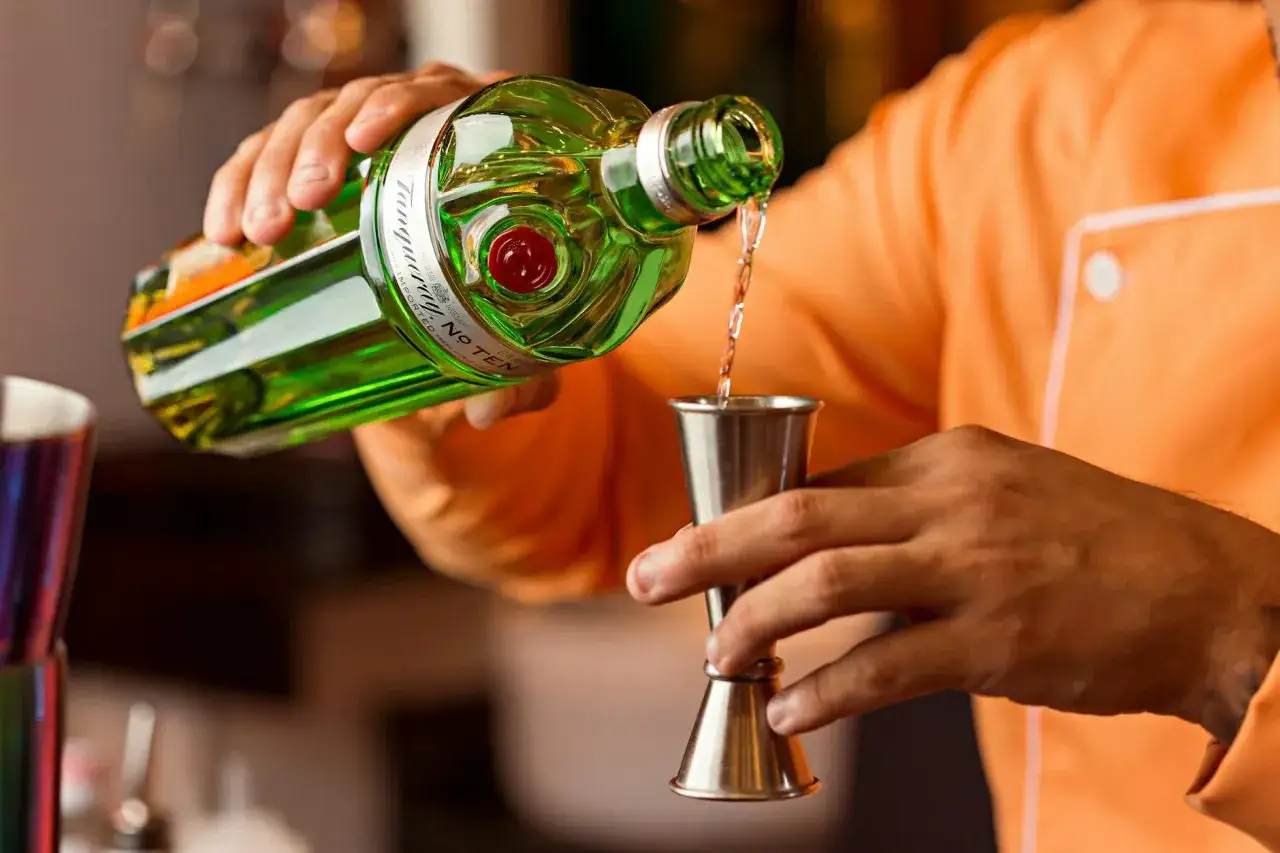 Barman nalewa gin do miarki. Czy to początek sztuczek, jak oszukują barmani, czy precyzyjne odmierzanie?
