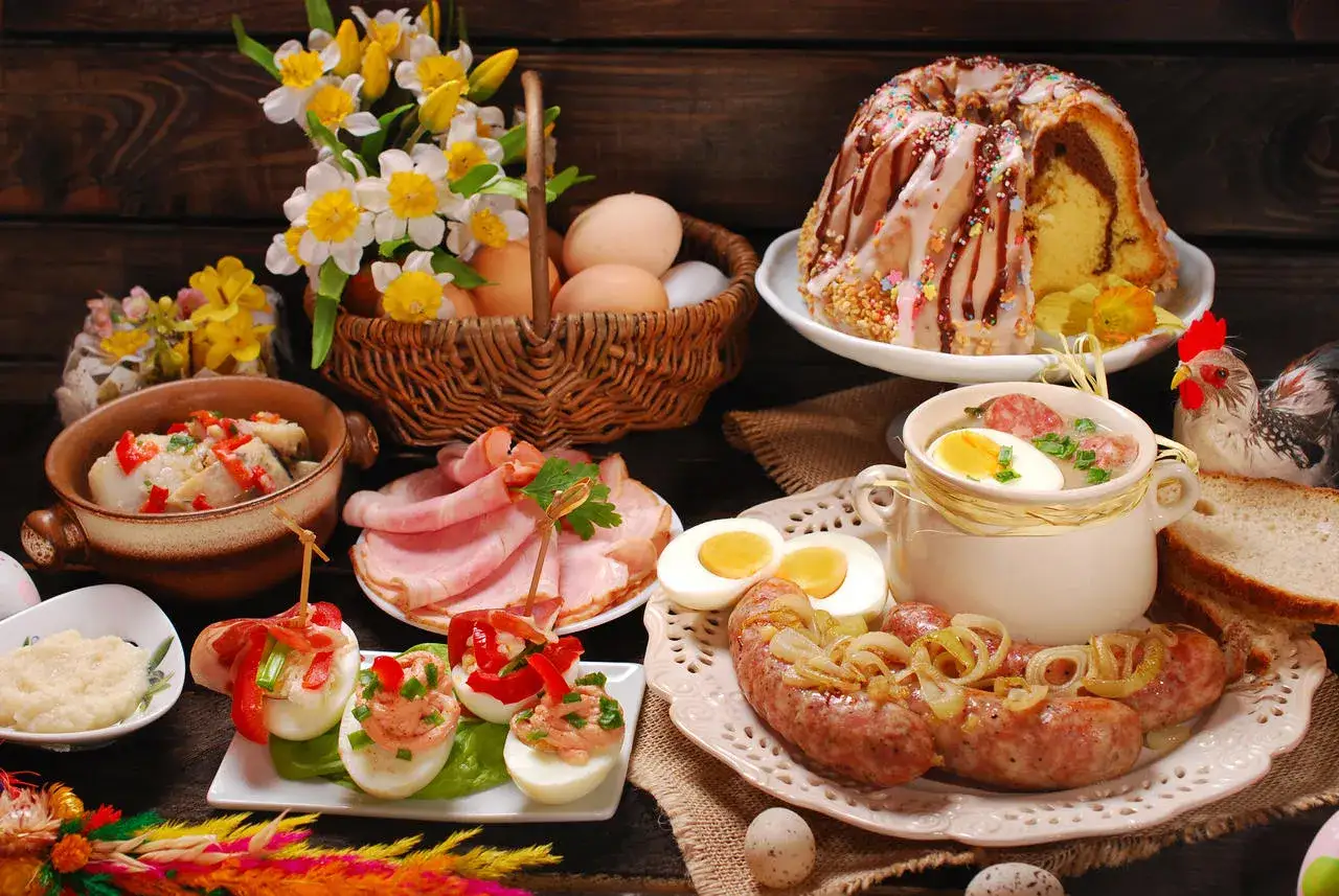 Co na obiad wielkanocny? Suto zastawiony stół: biała kiełbasa, jajka faszerowane, chrzan, wędliny, żurek, babka i bukiet żonkili.